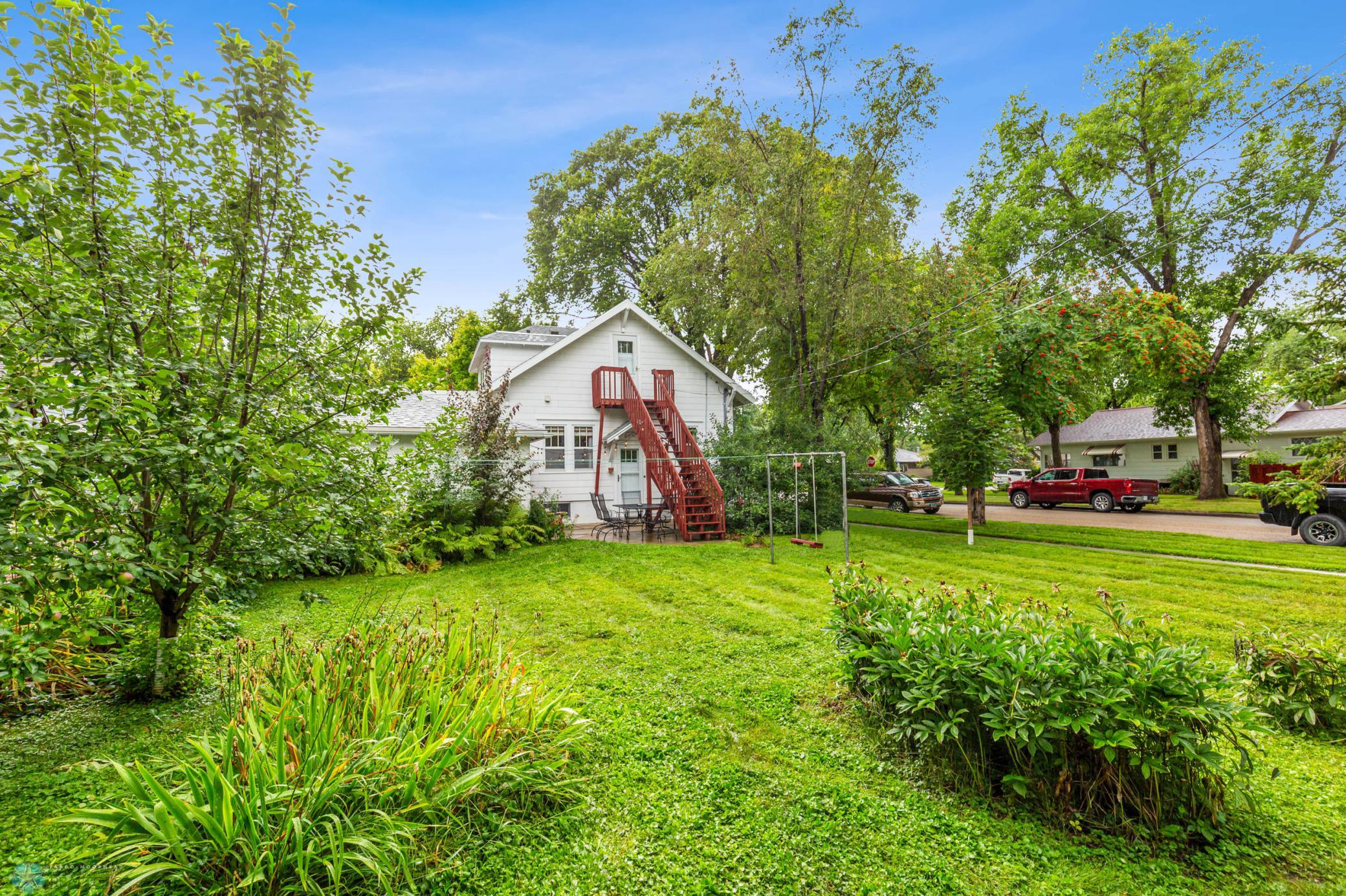 Large yard with extensive plants/trees