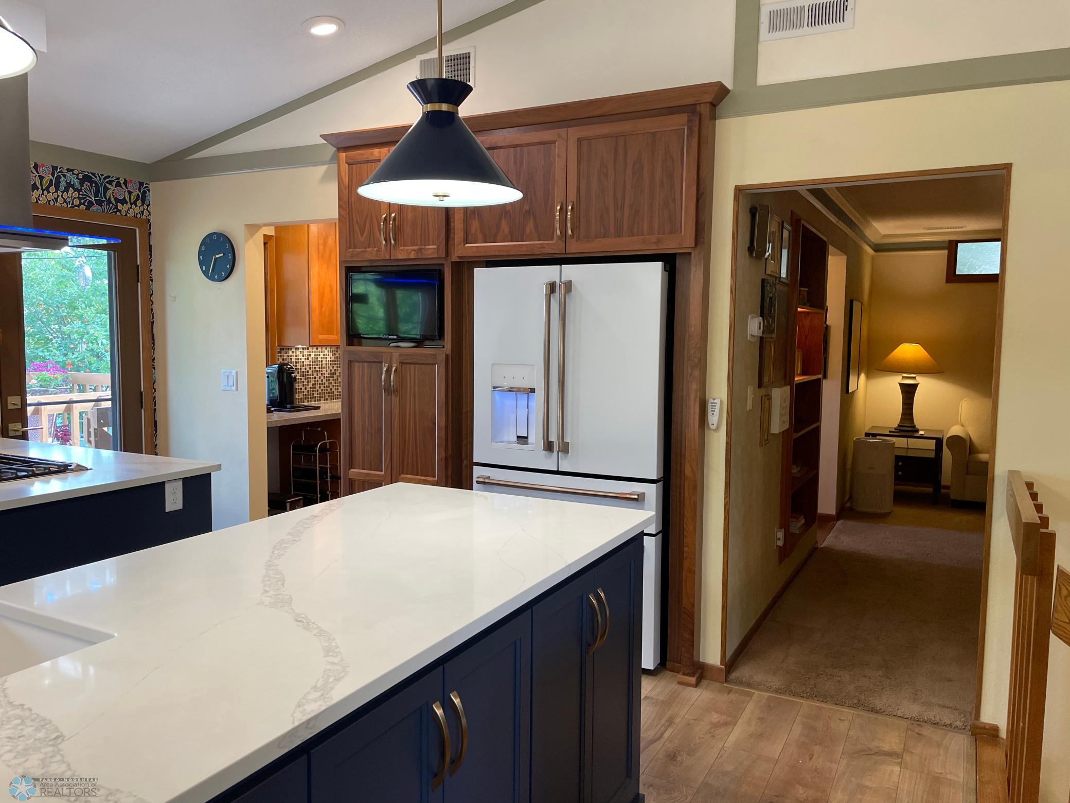 Kitchen - view to uppler level family room:den and office area entryways.jpg