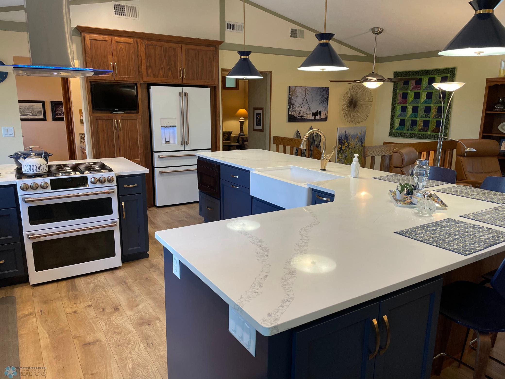 Kitchen - view from dining area to kitchen, stairway, and entry to upper level family room:den.jpg