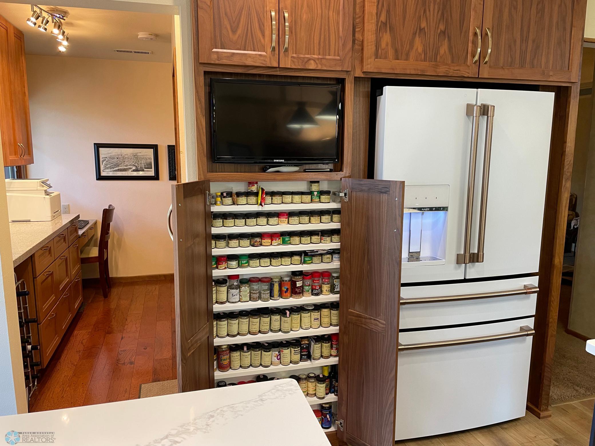 Kitchen - view to office area, spice cabinet, and refrigerator.jpg