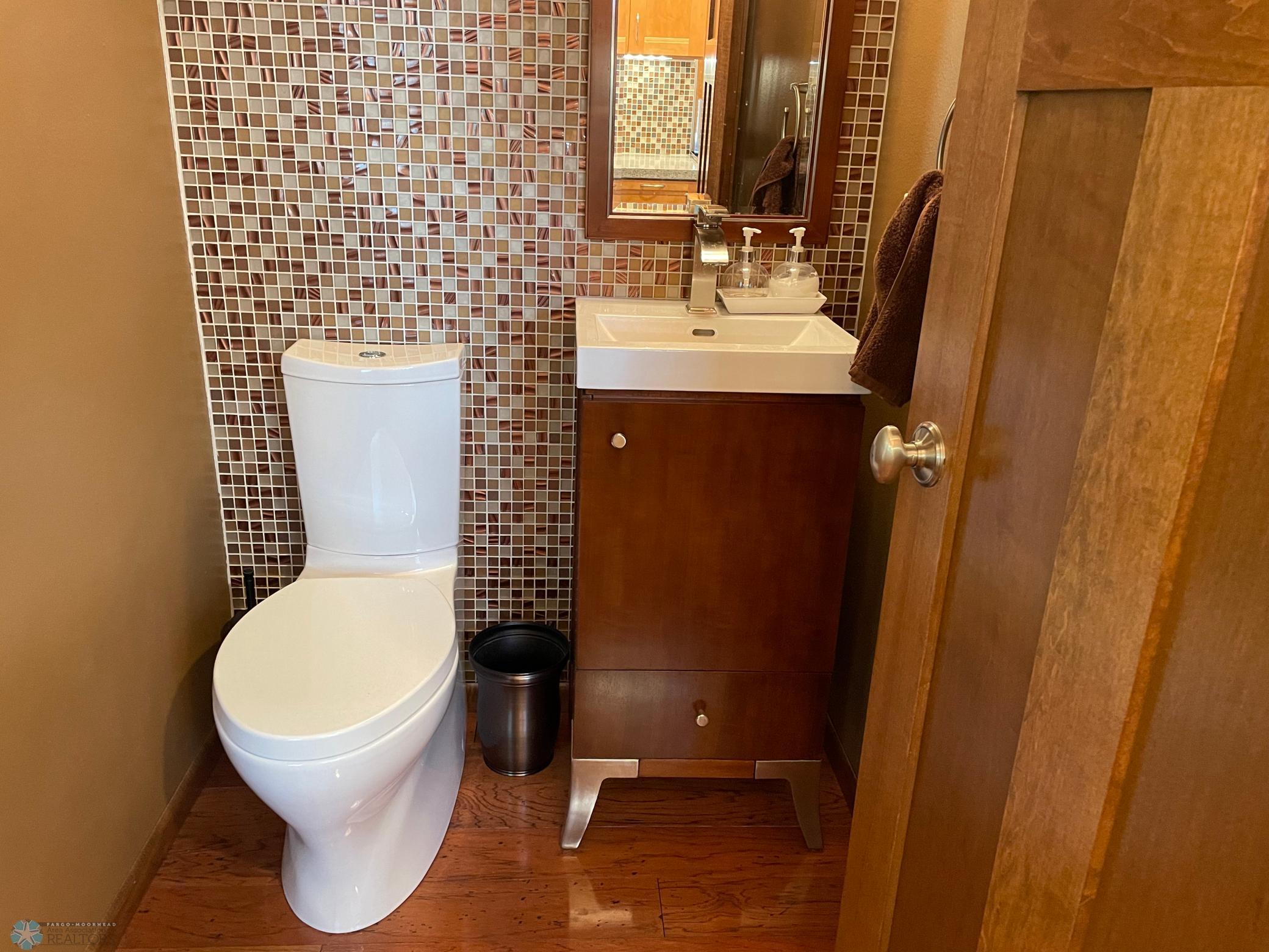 Half bath for guests on upper level - fully remodeled - tile accent wall.jpg