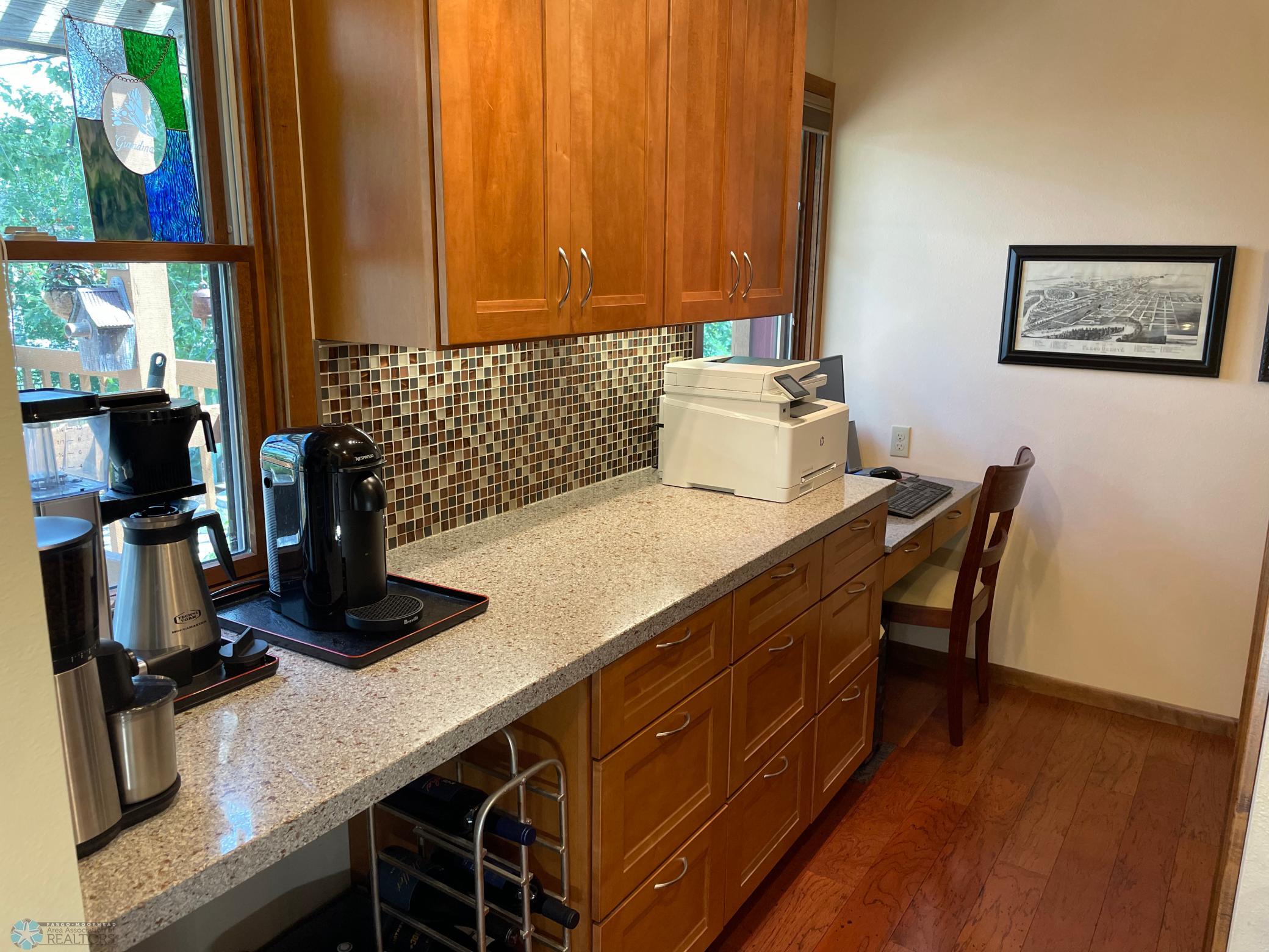 Office area next to kitchen with wet bar and cabinets .jpg