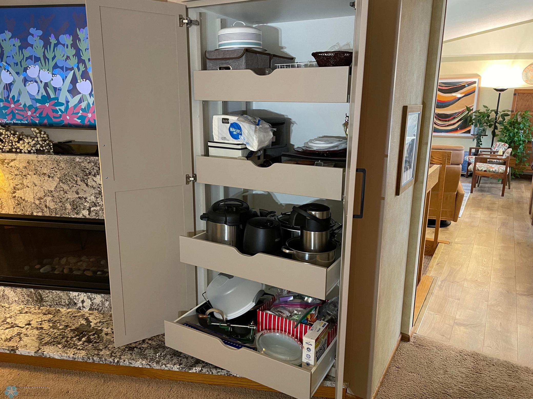 Upper level family room : den has extra pantry cabinet with pull-out shelves.jpg