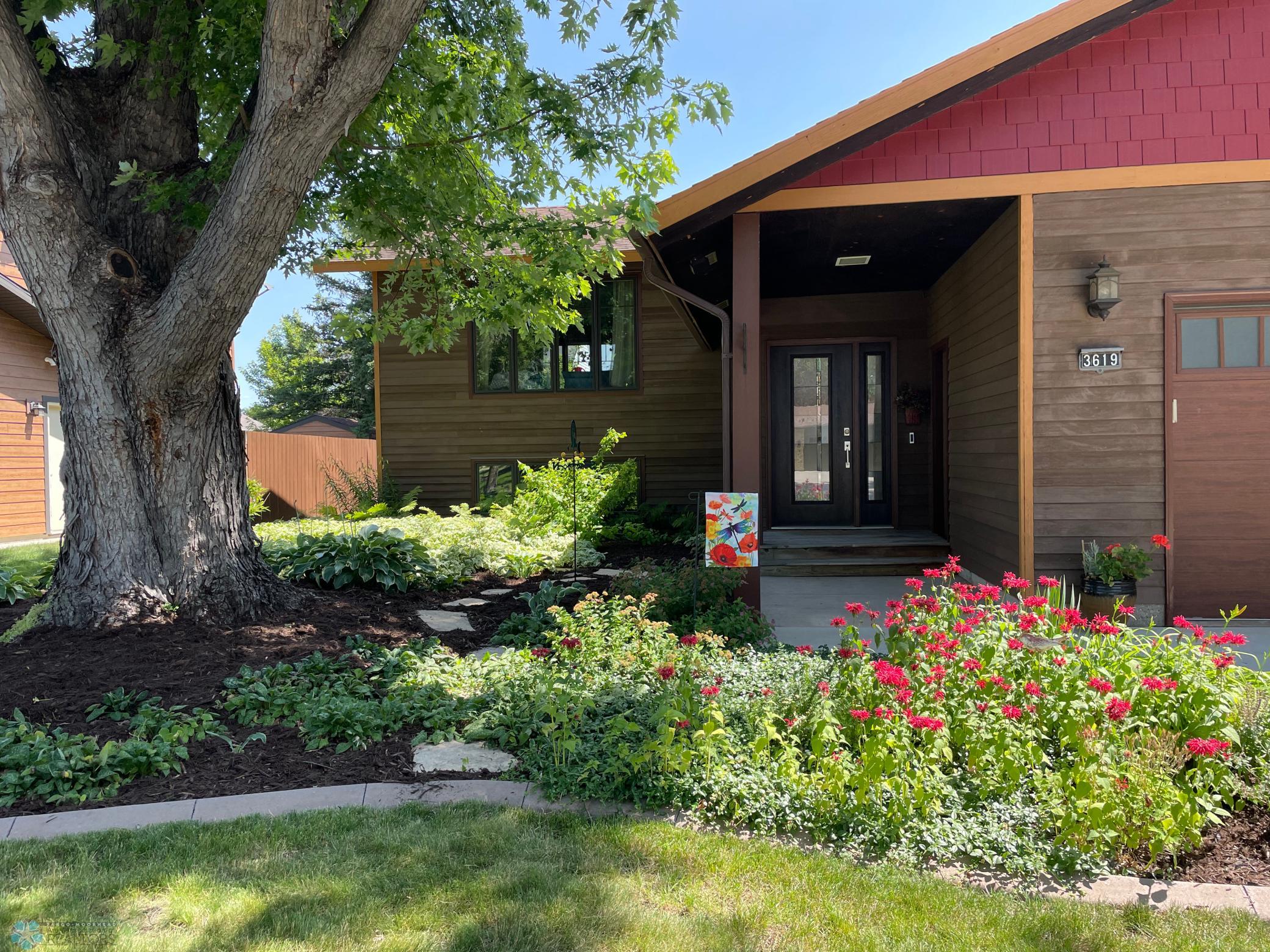 Exterior - Covered walk-way to the entry with updated decorative front door with sidelight.jpg