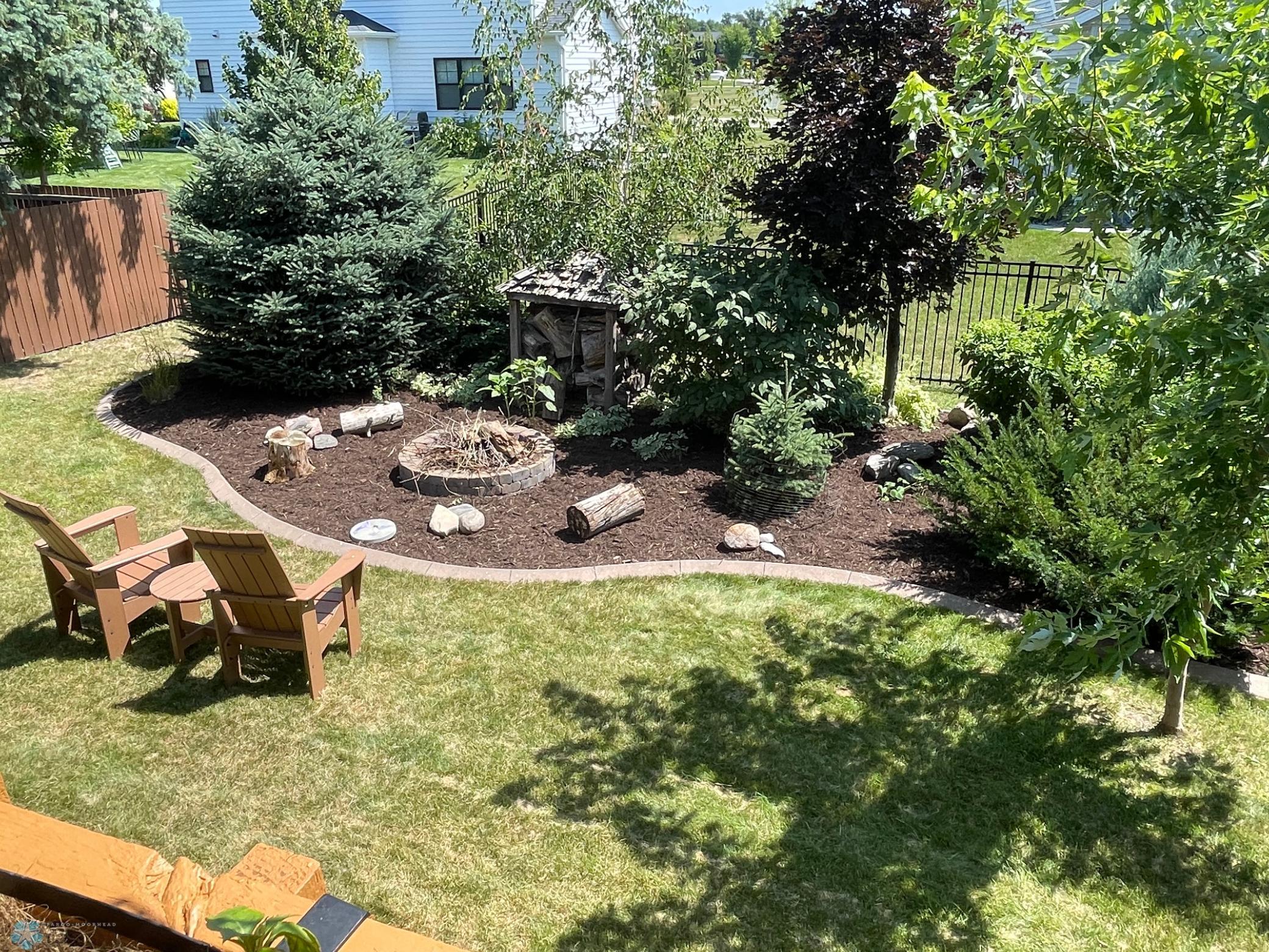 Backyard - view from deck to large landscaped area with fire pit.jpg