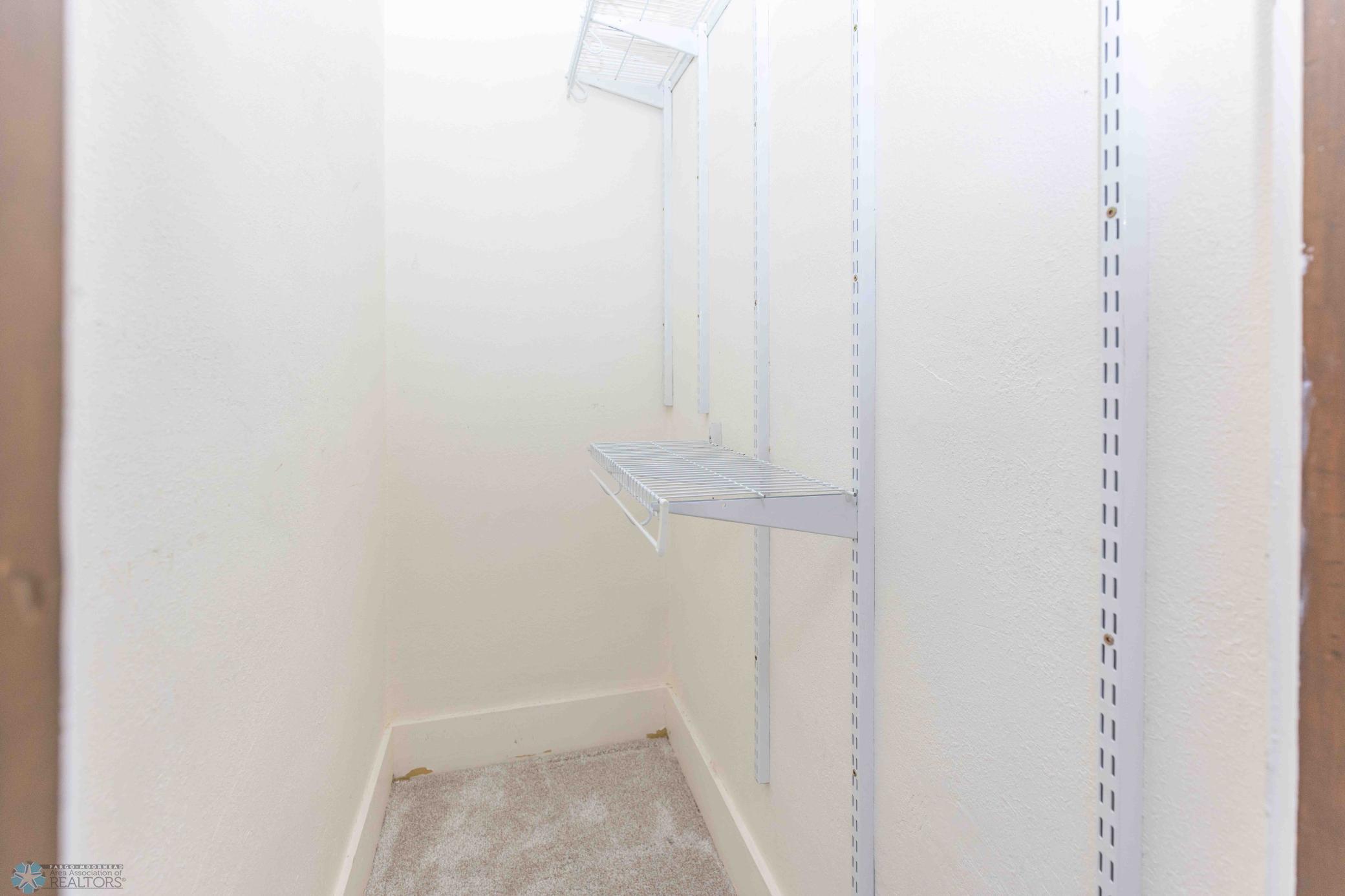 Primary bedroom walk in closet.