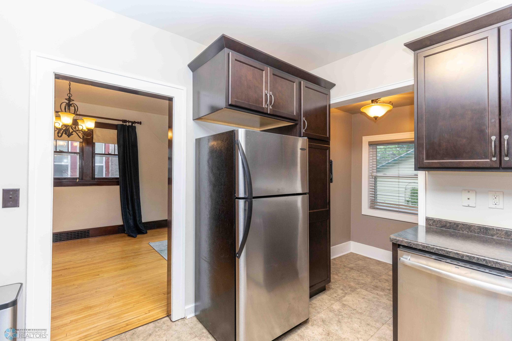Pantry next to refrigerator