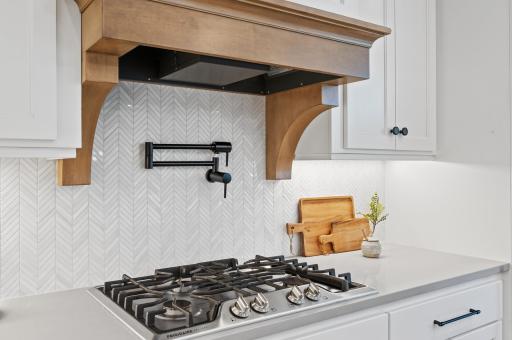 Enjoy the convenience and beauty of the pot filler and the luxury of the marble backsplash