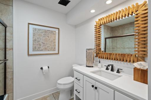 Third bath on main level featuring a shower and tub