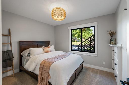 Fifth bedroom located in the lower level with built in drawers and additional closet