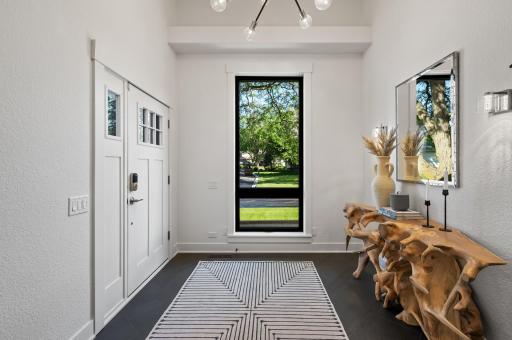 Stunning oversized entry with beautiful natural light and statement fixture