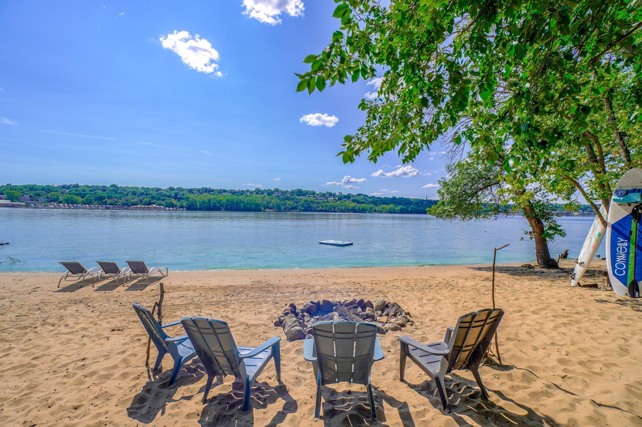 Beach chairs set up for a bit of daytime sun, which you have all day in Wisconsin, the floating raft is ready for the kids in the shallow swim area, the campfire is built for night time entertainment as you watch the paddlewheel boats cruise by