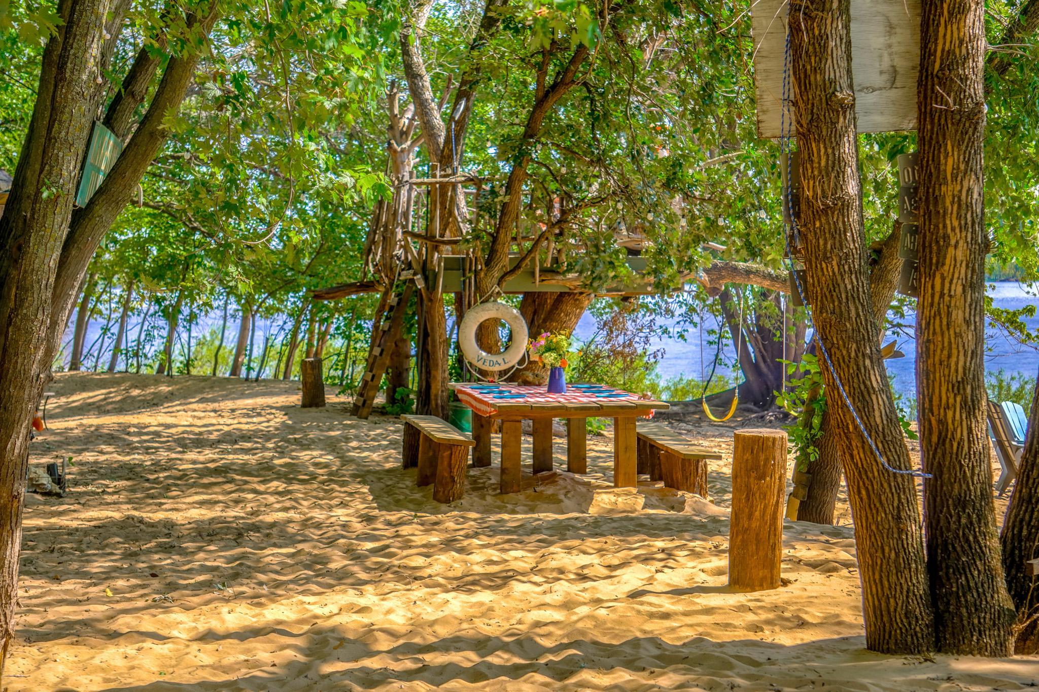 "WOW! REALLY?" Is what you hear when friends are invited to come down for dinner on the beach, the tree house is a great spot for kids to enjoy their snacks and dinner, or work on their art projects. The solid, huge picnic table fits up to 8 easily