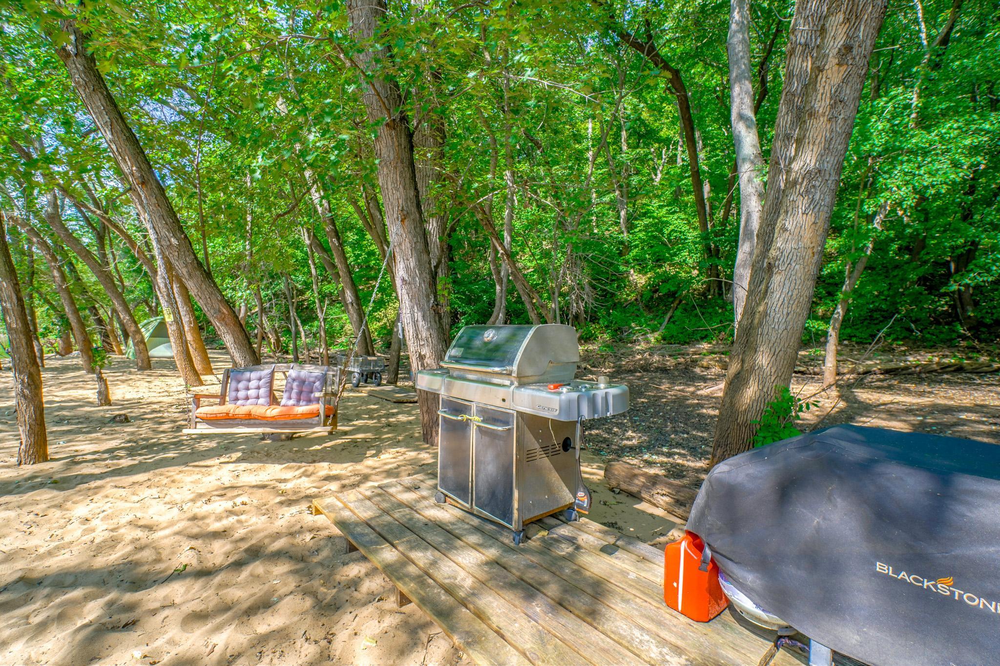 Chef's station! Large grill and a flat top set on a solid deck, and a swing nearby for those who like to watch the chef do their thing