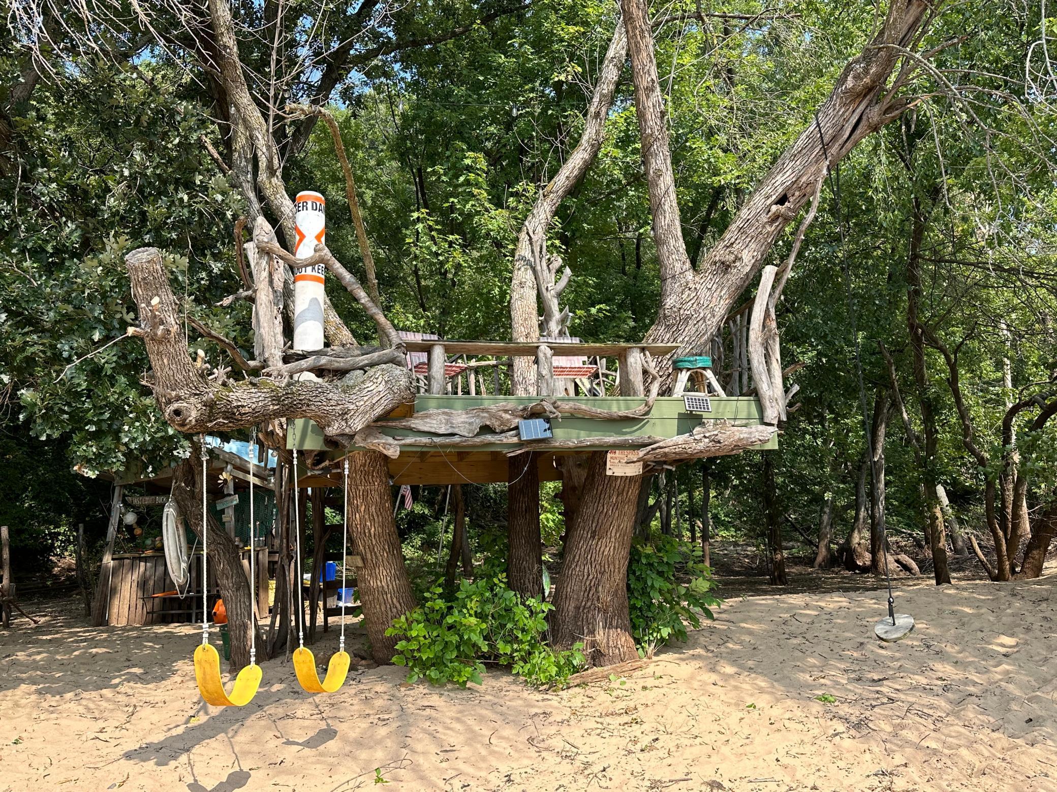 View of the treehouse from the beach, solar lights create a magical wonderland when the sun goes down...the no-wake float just floated up one day! The treasures that you find!