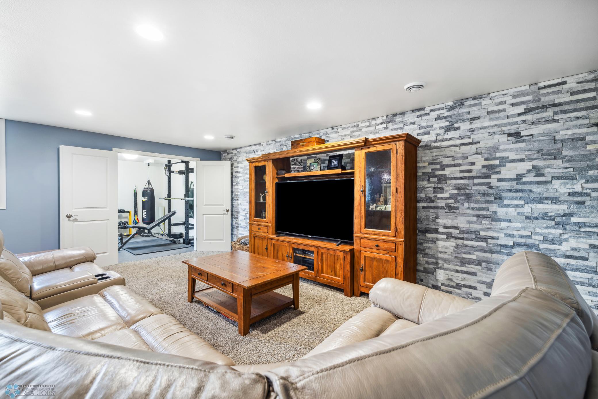 Family Room Featuring A Stone Accent Wall