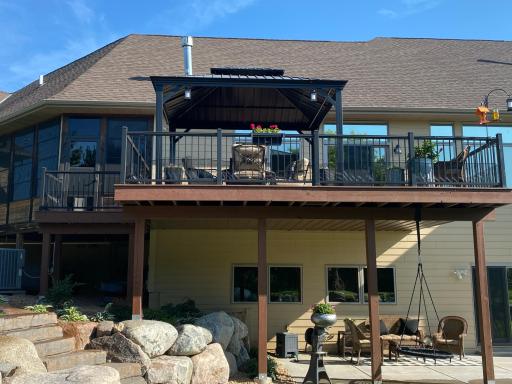 The Walkout Lower Level Leads to This 30 x 15 ft Patio, Partly Shaded by the Main Level Deck and with 11 Feet Partly Protected from Rain by Under Deck Roofing. The 3-Season Porch is at the Upper Left.