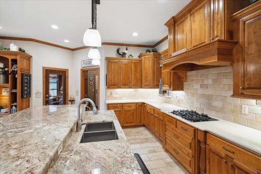 ...and as the Centerpiece this Large Center Island with Breakfast Bar Seating, Storage on All Sides, a Deep Undermount Sink, Culligan Reverse Osmosis Drinking Water System and the One of a Kind Granite Top Imported from Brazil.