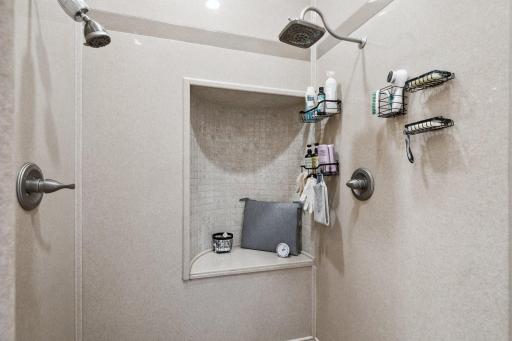 ...and This Luxury Walk In Shower. Remodeled in 2018 it Features Onyx Stone and Tile, Dual Shower Heads and a Sitting Area.