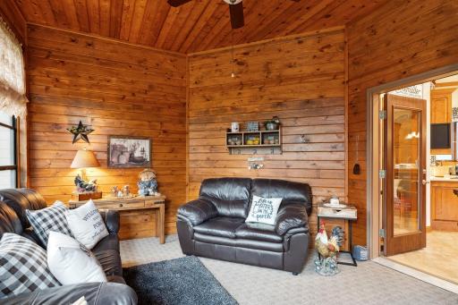 Enjoy the "Up North" Setting with Pine Planking and Seasonal Views of the Adjoining Property's Lake. With Southern Exposure and a Door that Opens to the Dining Area and Kitchen, You'll Want to Extend it's Use into the "4th Season," too!