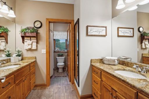 Full Lower Level Bath with Linen Closet, Opposite Vanities and Separated from the Tub/Shower and Toilet Areas.