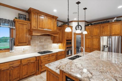 ...A Kitchen Window, Gas Stove Top with Cast Iron Grates, Range Hood, Under Cabinet and Pendant Lighting, Seemingly Endless Counter and Cabinet Space...