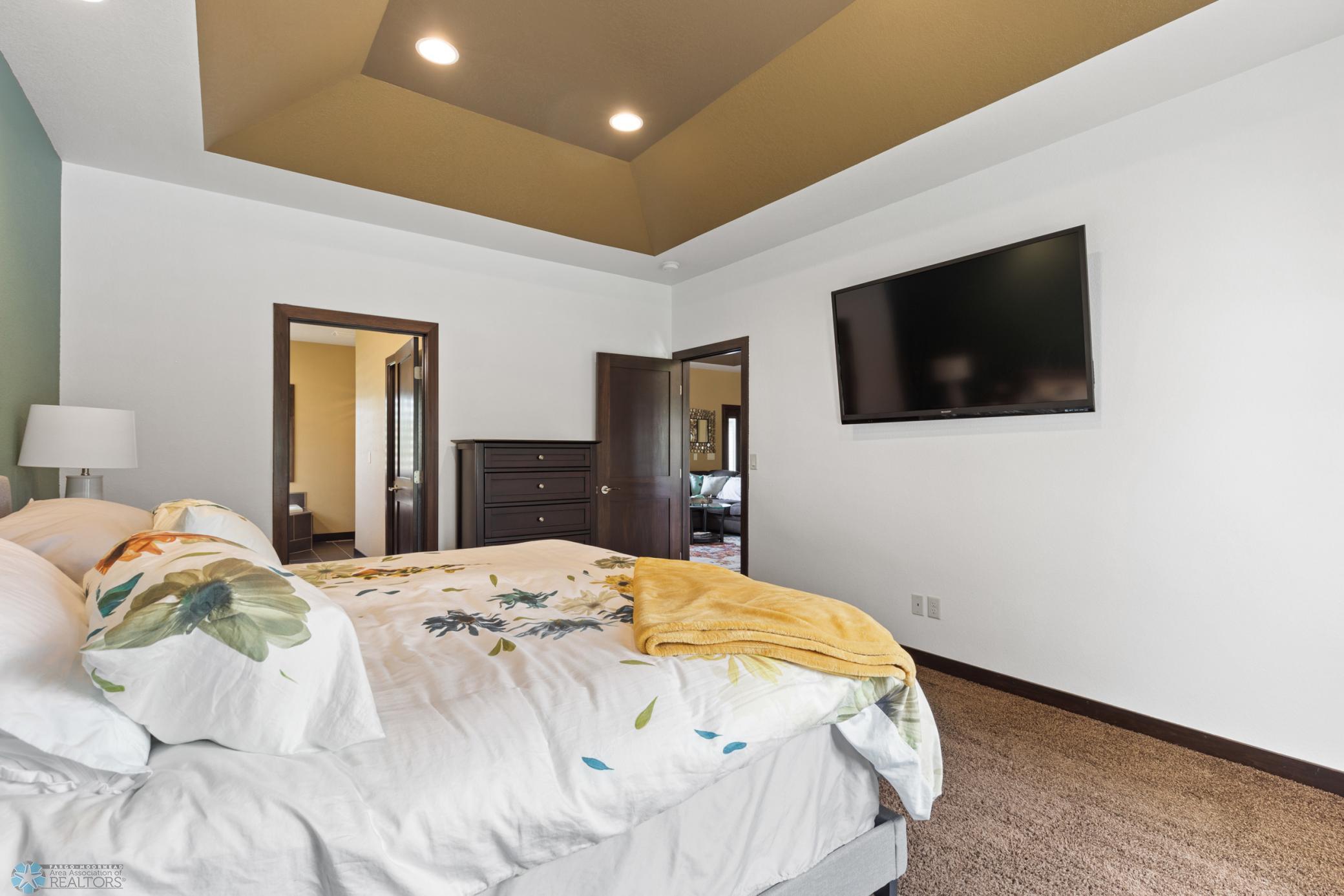 primary bedroom with tray ceiling