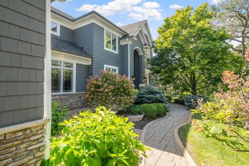 Front facade is wrapped in cedar shakes with stone accents