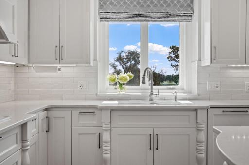 Stunning quartz countertops w/ timeless subway tile backsplash and a cast iron sink & deep window ledge over the sink