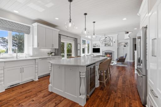 Enameled wood paneled ceilings & rustic maple hardwood flooring throughout