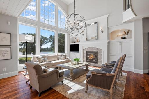 Pair of built-in entertainment cabinets feature storage, open display with accent lighting and beadboard accents