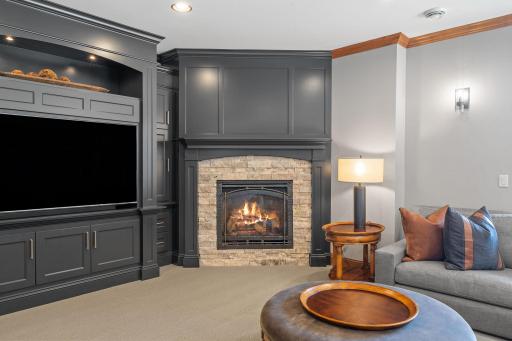 Corner gas fireplace with stone and enameled surround