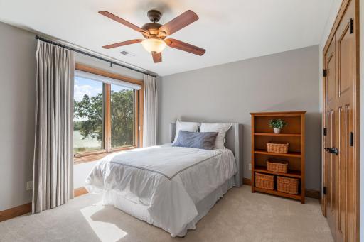 Bedroom 2 features ceiling fan and closet that offers custom storage organizer
