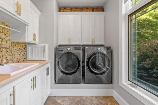 Laundry Room offers washer and dryer plus tile flooring