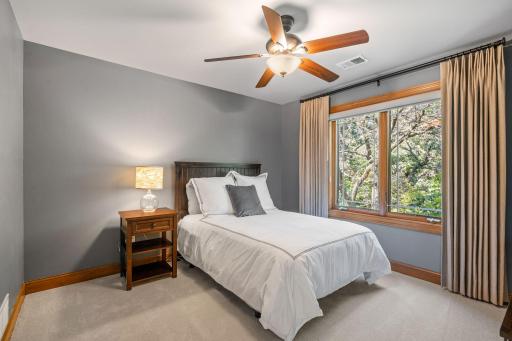 Bedroom 3 features ceiling fan and closet that offers custom storage organizer