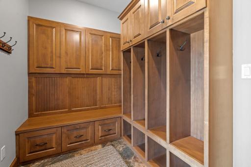 Pool Entry features full glass patio door w/ access to the lower level patio and pool. Additional room with lockers, bench and hooks. Access to the 3/4 bathroom and tile flooring