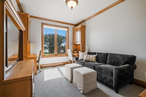 Bedroom 6 features pair of built-in workstations, crown molding, and walk-in closet w/ custom storage organizer