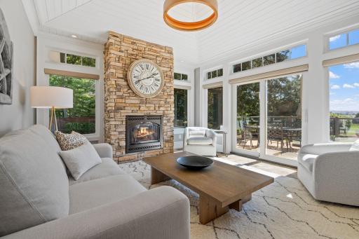 Sun Room features a full glass patio door with access to the deck & abundance of windows that offer incredible views of the property and Legends Golf