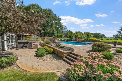 Decorative concrete retaining walls are strategically placed and define outdoor spaces