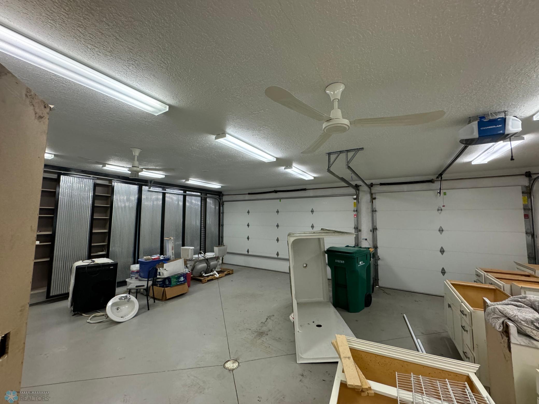 Finished garage - with in-floor heat, sliding door storage & floor drain.