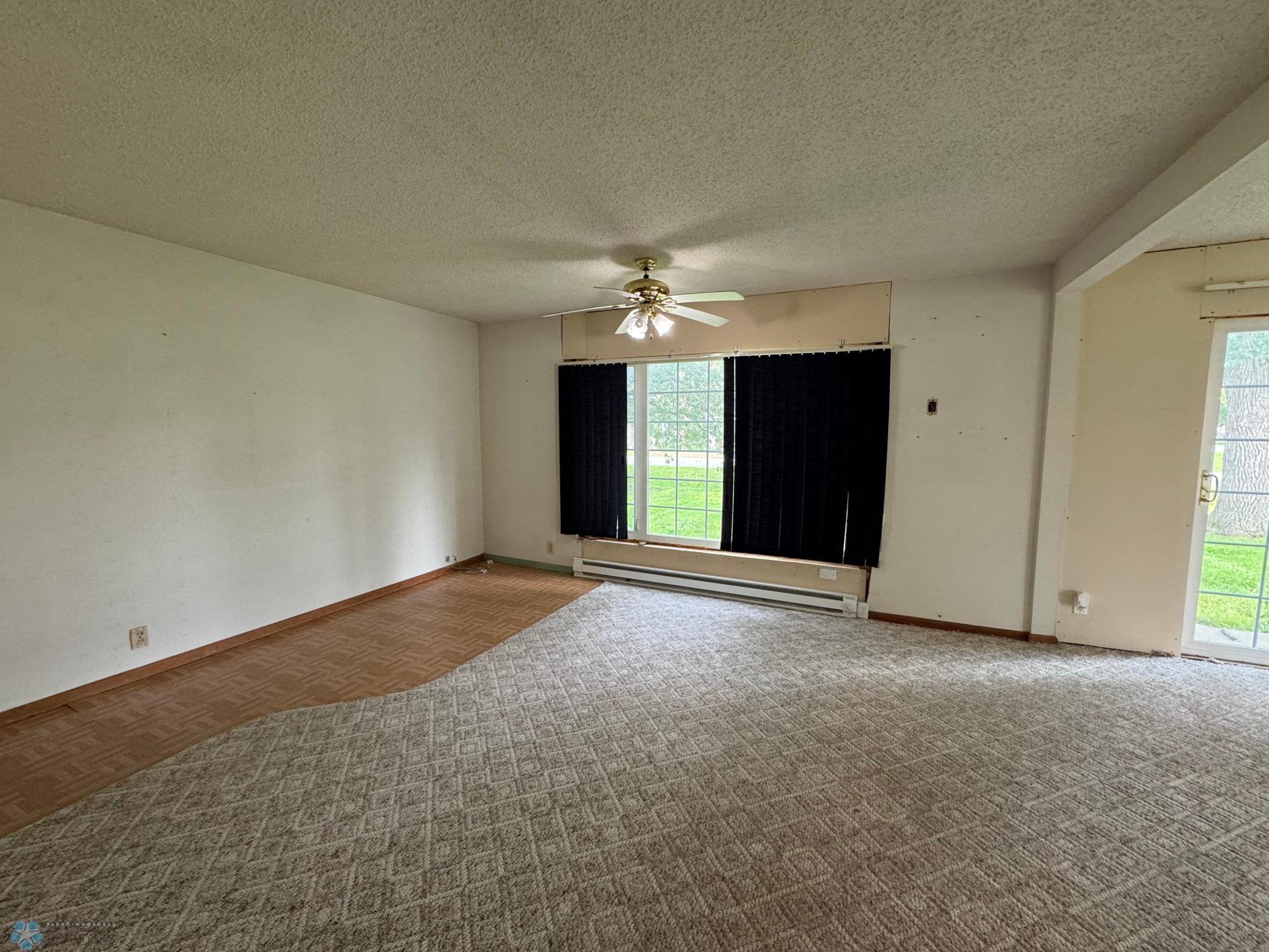 Half of living room - hard surface floor had been used for office/library space