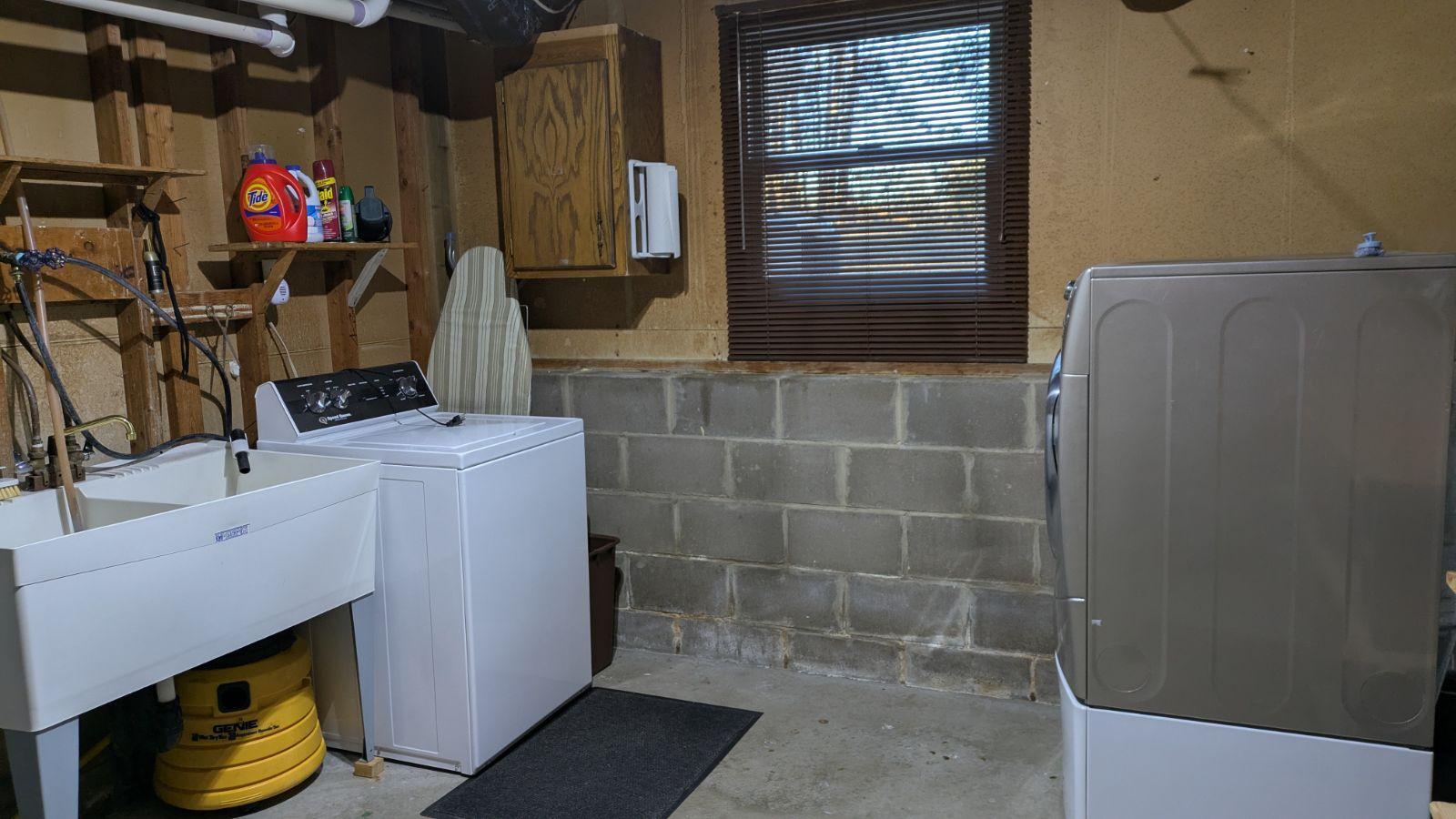 Laundry/Utility room with replaced window and lots of wall cabinets
