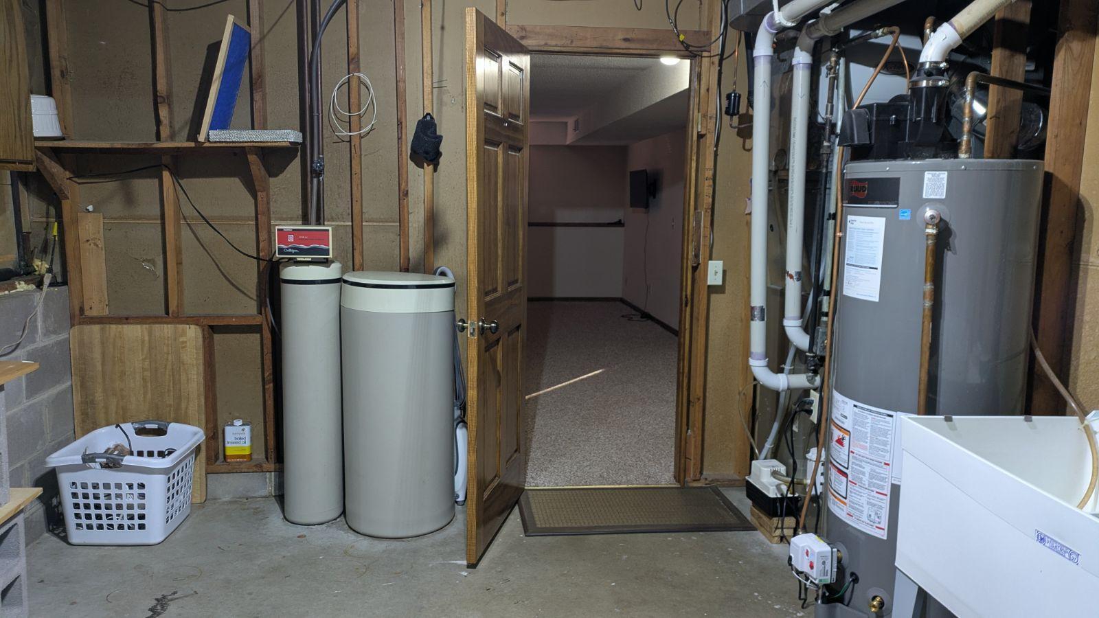 Utilities and view into FR. Panel to "well room" and extra storage behind laundry basket. Laundry area also has double tub utility sink.