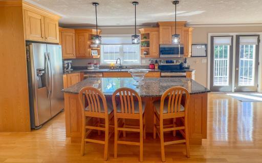 The breakfast bar is a great spot to sit and visit or extra workspace in the kitchen.