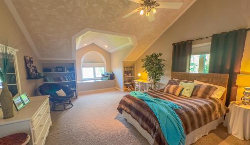 Upper level bedroom and window seat and built-in selves.