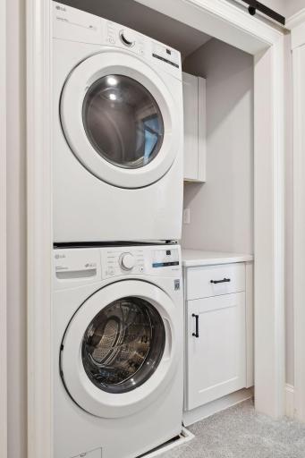 Enjoy the convenience of a washer and dryer in the primary suite with sliding door to close off laundry closet.