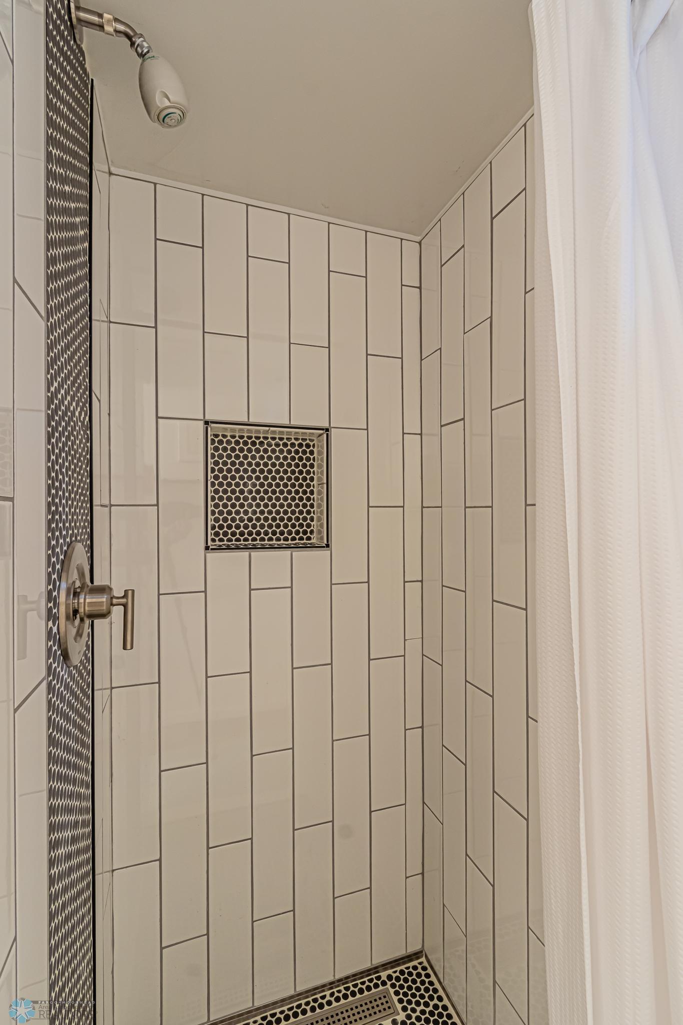 Tiled shower in Lower Level Bathroom