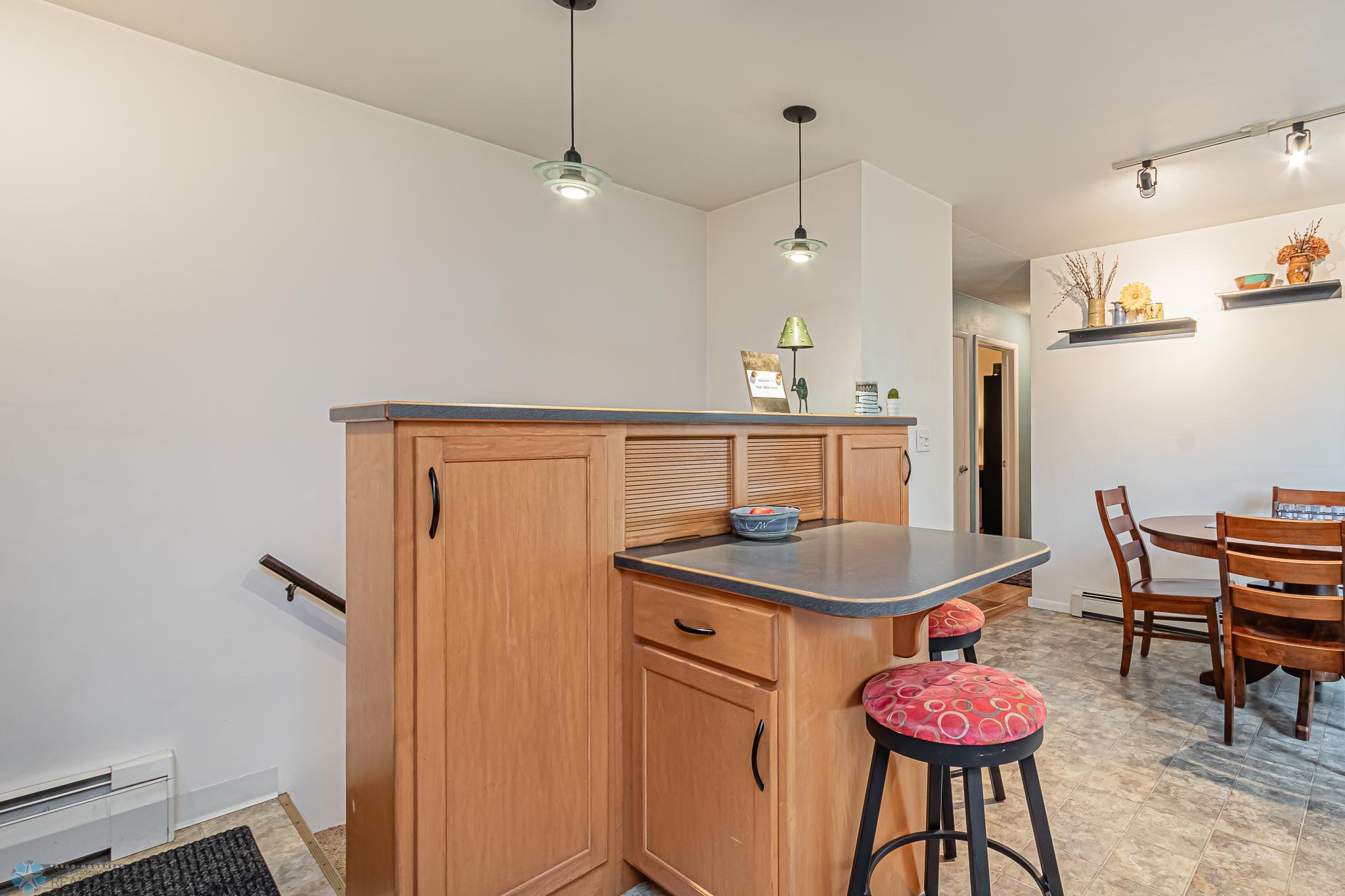 Breakfast bar and storage in Kitchen - stairs to basement