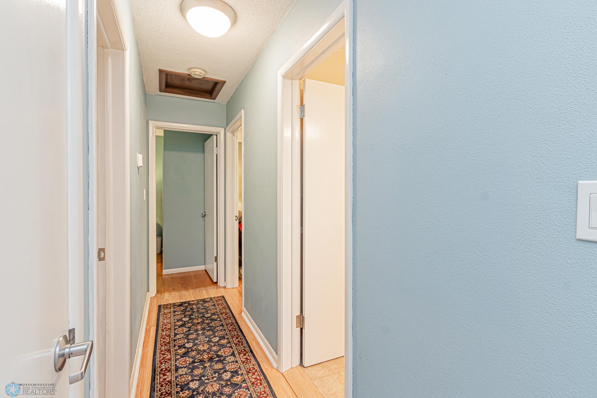 Hallway to main floor bedrooms and bathroom