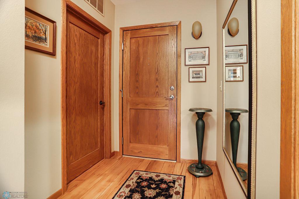 Unit foyer. Entry door on right, utility room/closet on left